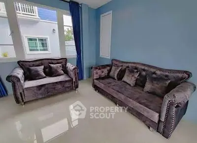 Stylish living room with plush velvet sofas and large windows