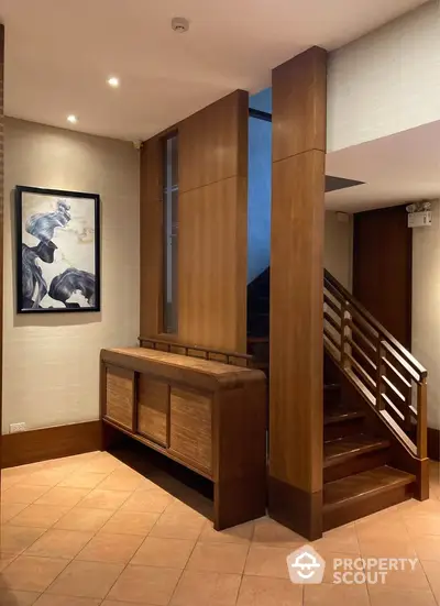 Elegant wooden staircase with modern art in a stylish interior