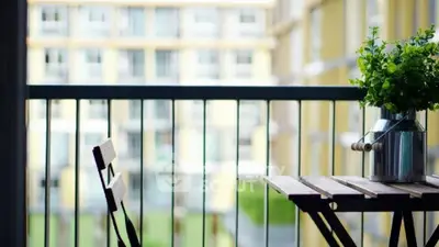 Charming balcony with cozy seating and lush greenery, perfect for relaxation and enjoying the view.
