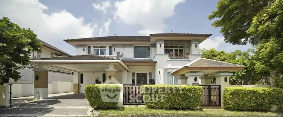 Stunning two-story house with lush greenery and modern architecture in a serene neighborhood.