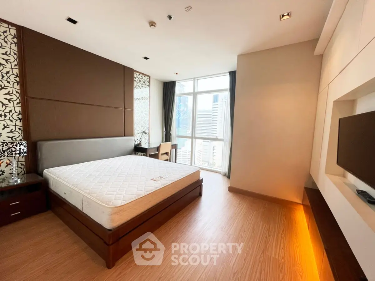 Spacious modern bedroom with city view and elegant decor