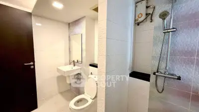 Modern bathroom with sleek fixtures and white tile design