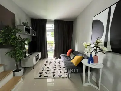 Stylish modern living room with sleek furniture and large window view