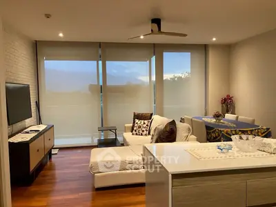 Modern living room with stylish decor and large windows offering scenic views.