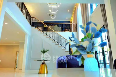 Luxurious modern living room with elegant staircase and stylish decor