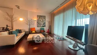 Luxurious modern living room with elegant decor and large windows offering stunning city views.