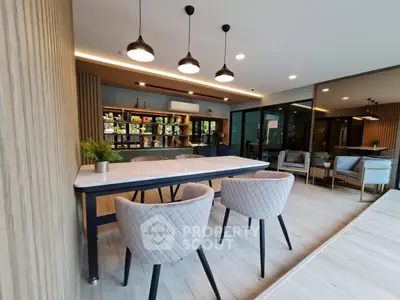 Modern dining area with stylish chairs and elegant lighting in a contemporary home.