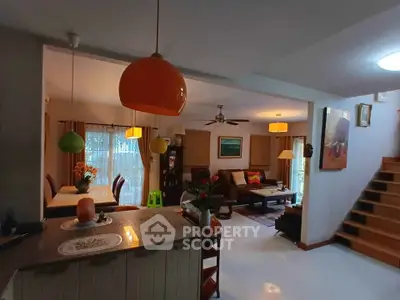 Charming open-plan living room with modern decor and vibrant lighting