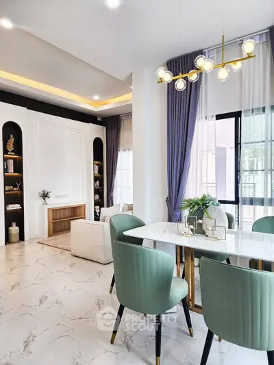 Elegant dining area with modern chandelier and stylish decor in a luxurious home interior.