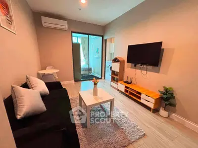 Modern living room with cozy sofa, wall-mounted TV, and stylish decor in a contemporary apartment.