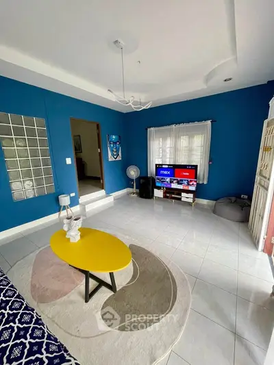 Charming living room with vibrant blue walls and modern decor