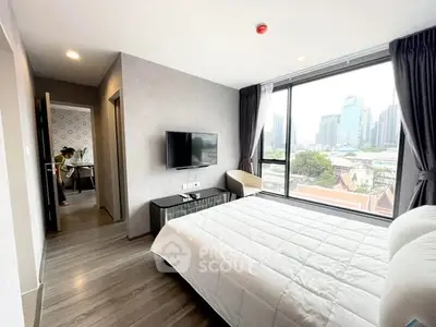 Modern bedroom with city view, large window, and stylish decor in urban apartment.
