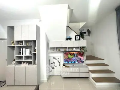 Modern living room with stylish staircase and built-in storage