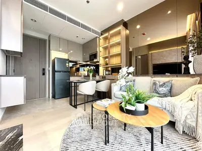 Modern open-layout kitchen and living room with stylish decor and natural light