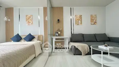 Modern studio apartment with stylish decor and cozy furnishings, featuring a comfortable bed and chic living area.