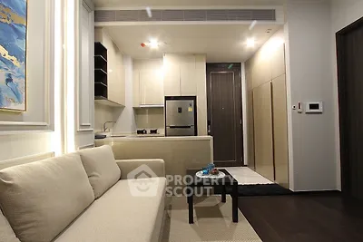 Modern open-plan kitchen and living room with sleek design and neutral tones.