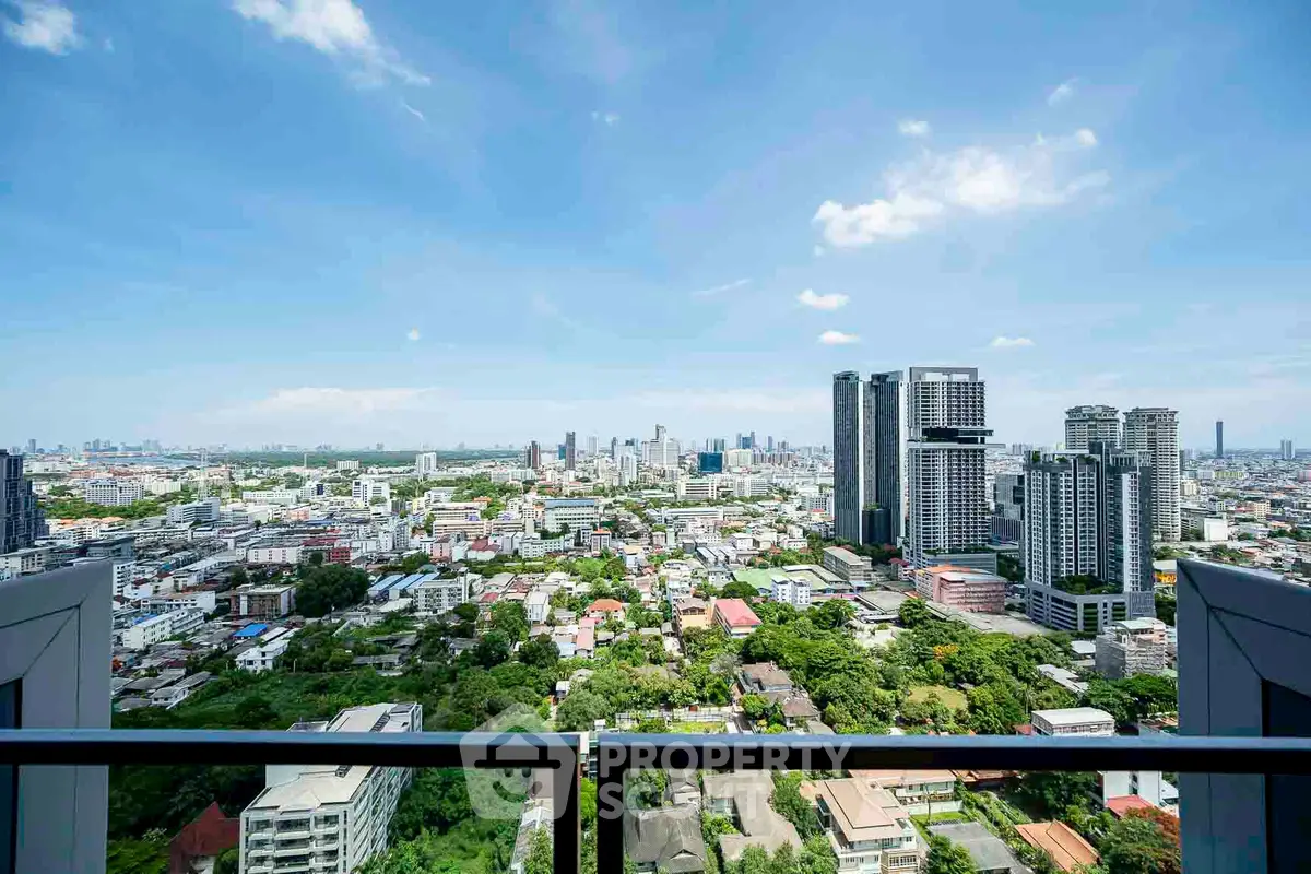 Stunning cityscape view from a high-rise balcony, showcasing urban skyline and lush greenery.