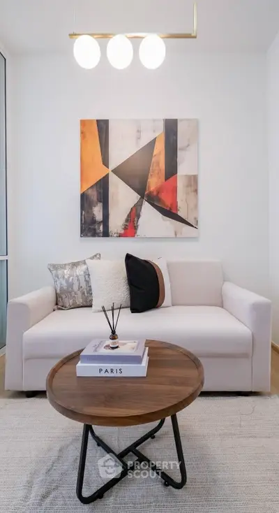 Modern living room with stylish sofa and abstract art, perfect for contemporary urban living.