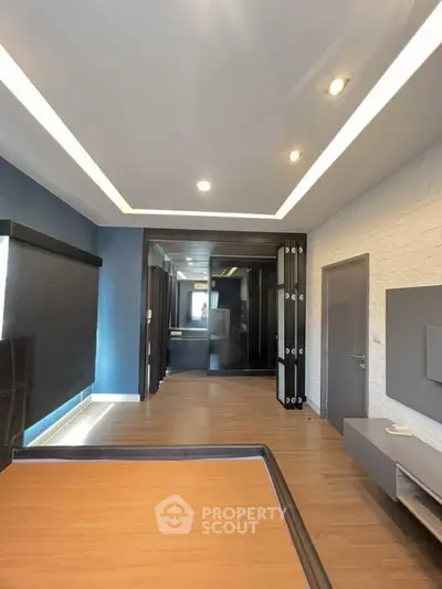 Modern living room with sleek design and recessed lighting