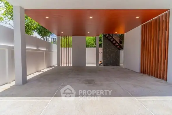 Spacious modern carport with wooden ceiling and open design