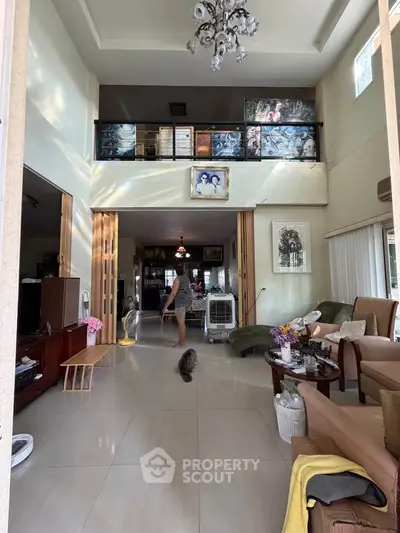 Spacious living room with high ceiling and modern decor