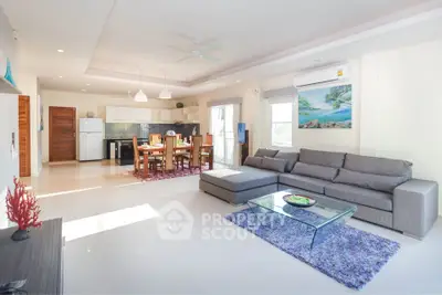 Spacious open-plan living room with modern kitchen and stylish decor