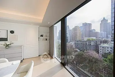 Luxurious modern living room with stunning city view through floor-to-ceiling windows.