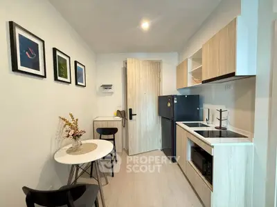 Modern compact kitchen with dining area in stylish apartment