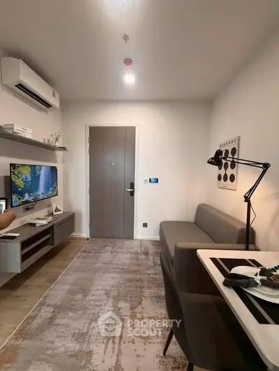 Modern living room with sleek furniture and wall-mounted TV