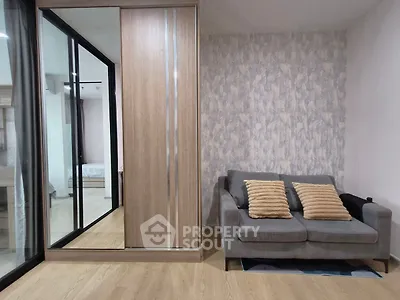 Modern living room with stylish sofa and mirrored wardrobe