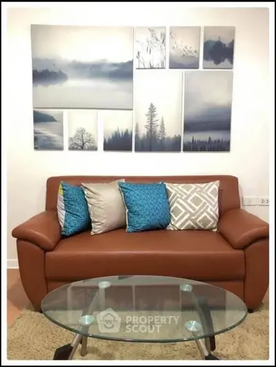 Stylish living room with modern sofa, elegant cushions, and artistic wall decor.
