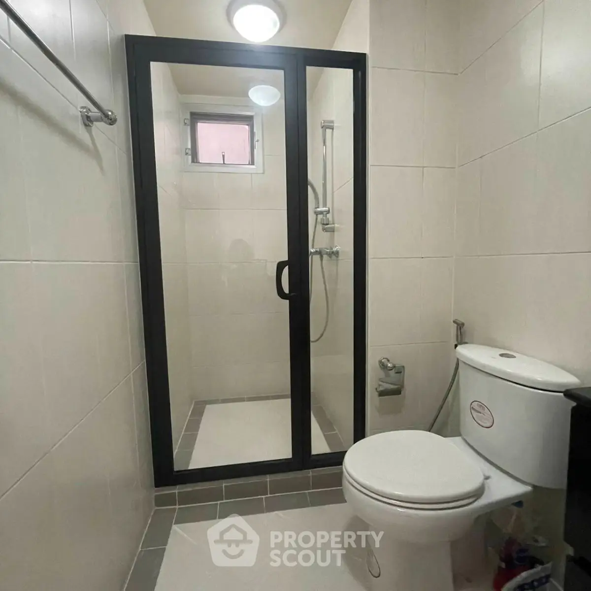 Modern bathroom with glass shower enclosure and sleek fixtures.