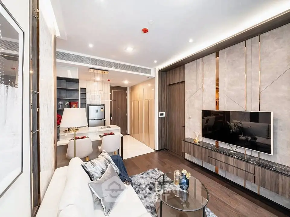Luxurious modern living room with elegant decor and open layout, featuring a stylish TV unit and cozy seating area.