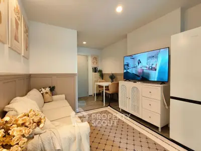 Cozy living room with modern decor and large TV, perfect for relaxation.