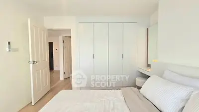 Bright and cozy bedroom with modern wardrobe and comfortable bedding