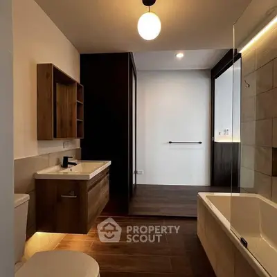 Modern bathroom with sleek wooden accents and ambient lighting