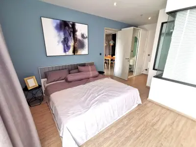 Modern bedroom with stylish decor and wooden flooring