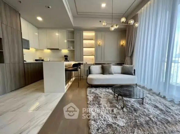 Luxurious modern living room with open kitchen, elegant lighting, and plush rug in high-rise apartment.