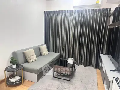 Modern living room with sleek gray sofa and stylish decor
