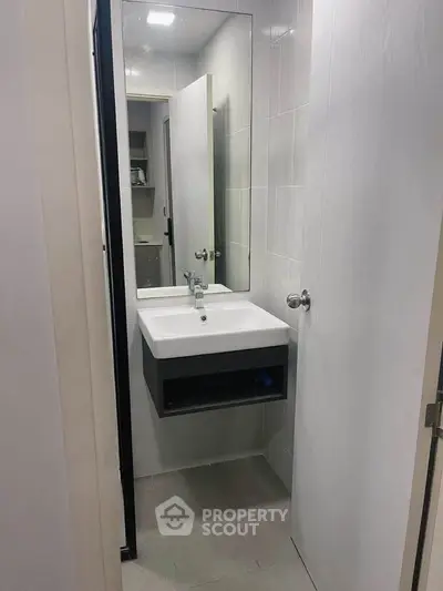 Modern bathroom with sleek sink and mirror in compact space