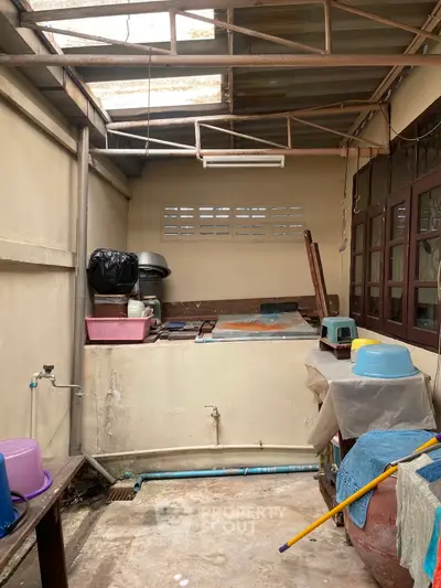 Spacious utility area with natural light, ideal for storage or laundry setup.