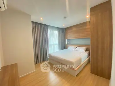 Modern bedroom with wooden accents and large window in a stylish apartment.
