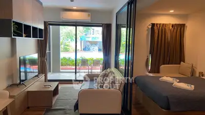 Modern condo with pool view, open living area, and cozy bedroom.