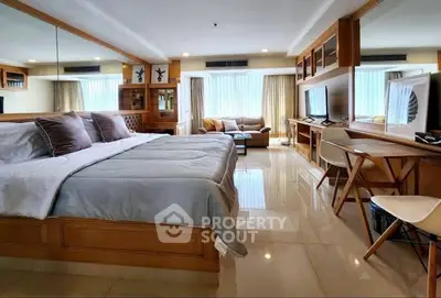 Spacious bedroom with modern decor and natural light