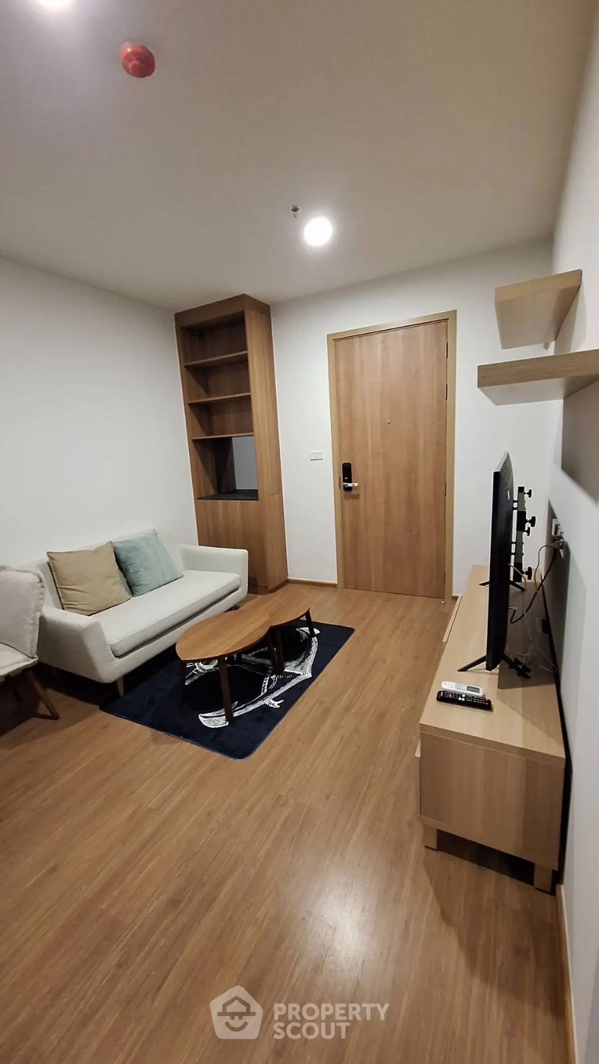 Modern living room with wooden flooring and minimalist furniture