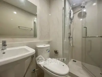Modern bathroom with sleek fixtures and glass shower enclosure