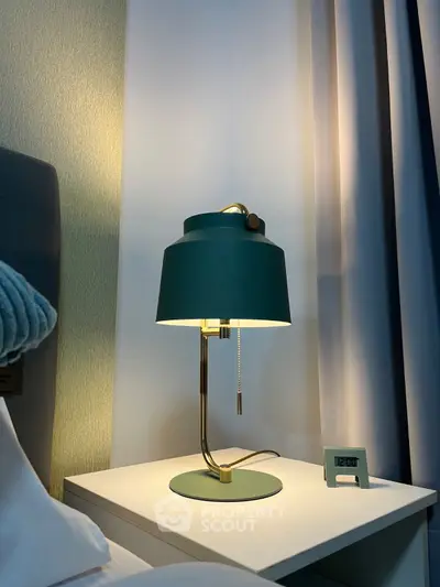 Elegant bedroom nightstand with modern lamp and digital clock, perfect for cozy ambiance.