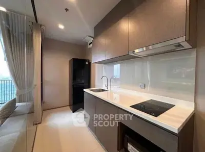 Modern kitchen with sleek cabinetry and built-in appliances in a stylish apartment.