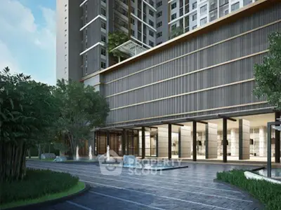 Modern apartment building entrance with sleek design and lush greenery.