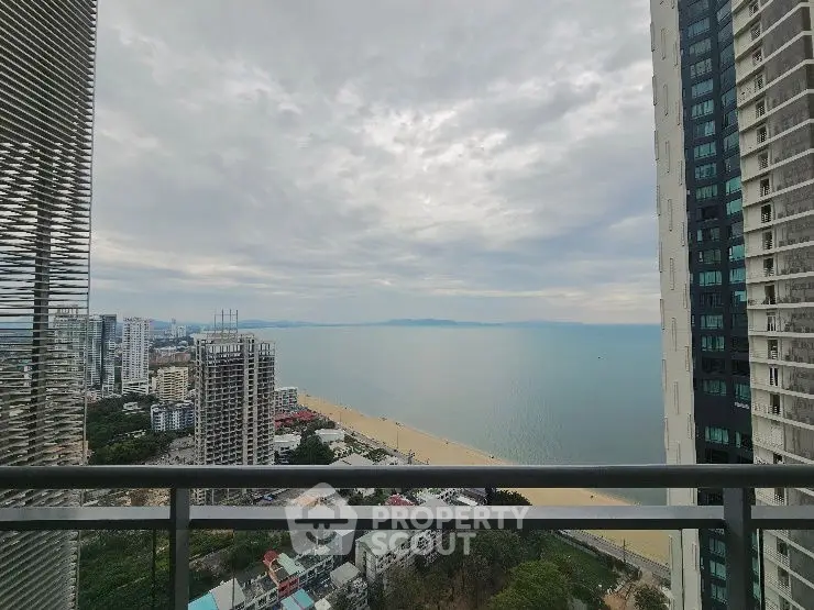 Stunning ocean view from high-rise balcony overlooking cityscape and beach.